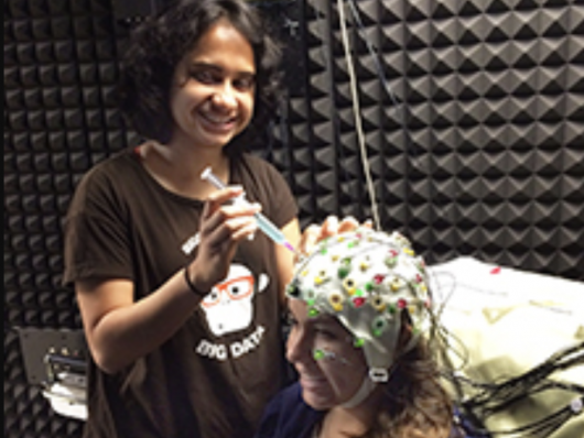 An image of a woman performing a test on a woman's head